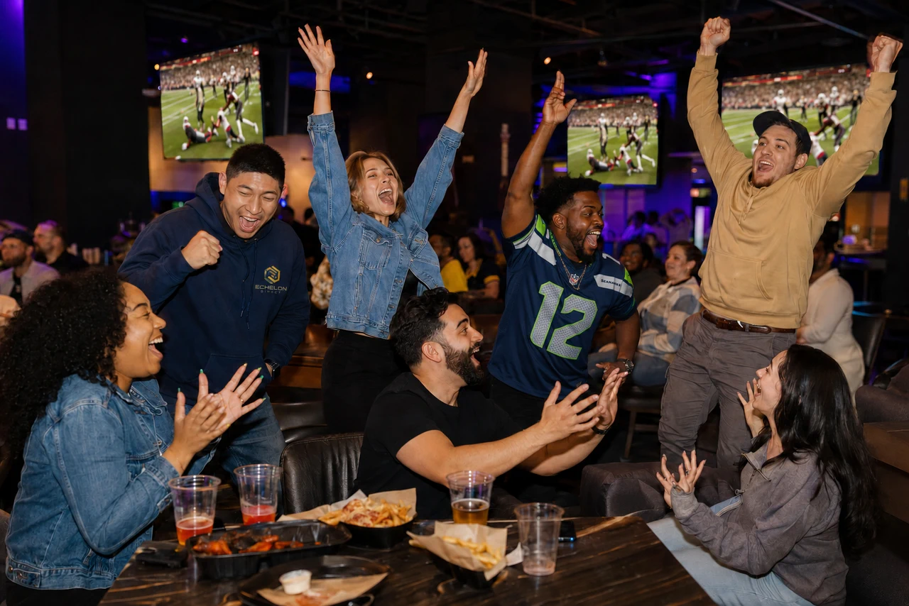 Culture concept showing colleagues celebrating during a football watch party