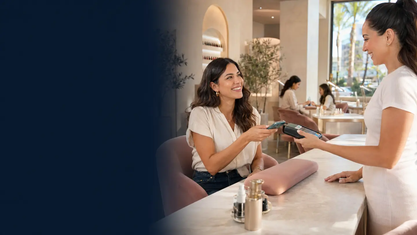 A nail-salon merchant completing a contactless payment with a customer